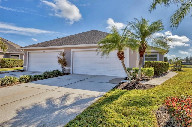 view of front of house with a garage and a front yard