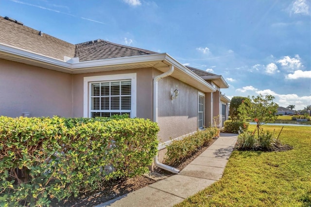 view of property exterior with a yard