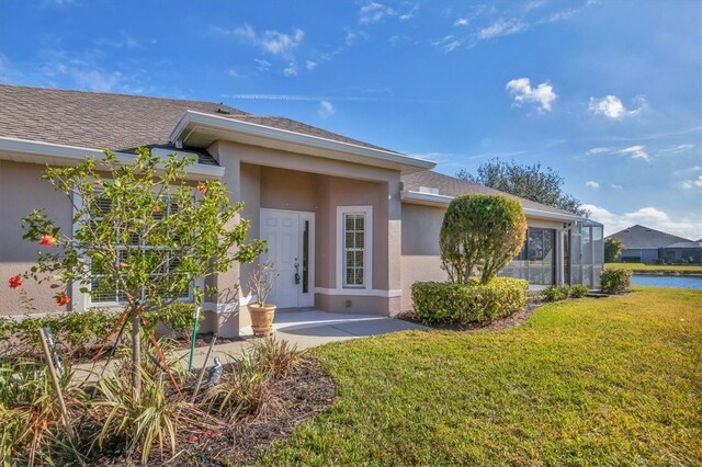 property entrance with a yard