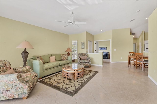 tiled living room with vaulted ceiling and ceiling fan