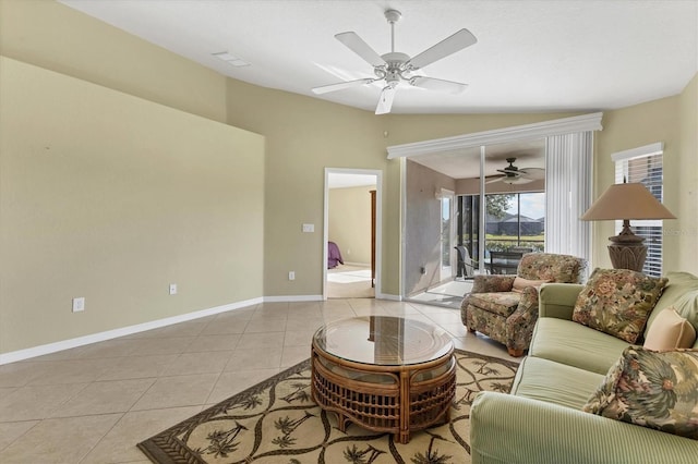 living room featuring vaulted ceiling, light tile patterned floors, and ceiling fan