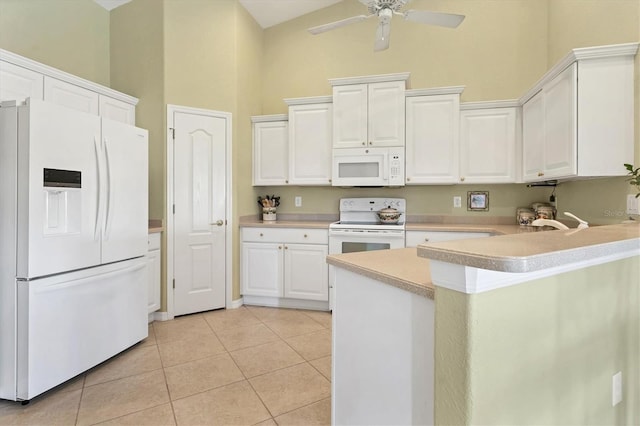 kitchen featuring light tile patterned floors, white appliances, white cabinetry, a high ceiling, and kitchen peninsula