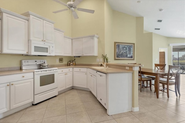 kitchen with white cabinetry, light tile patterned floors, white appliances, and kitchen peninsula