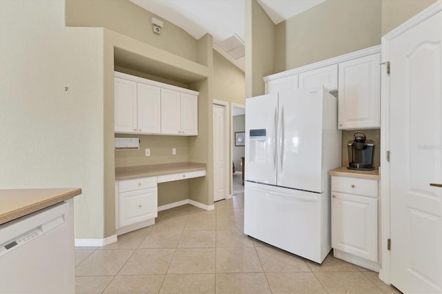 kitchen featuring white cabinetry, white appliances, built in desk, and light tile patterned floors