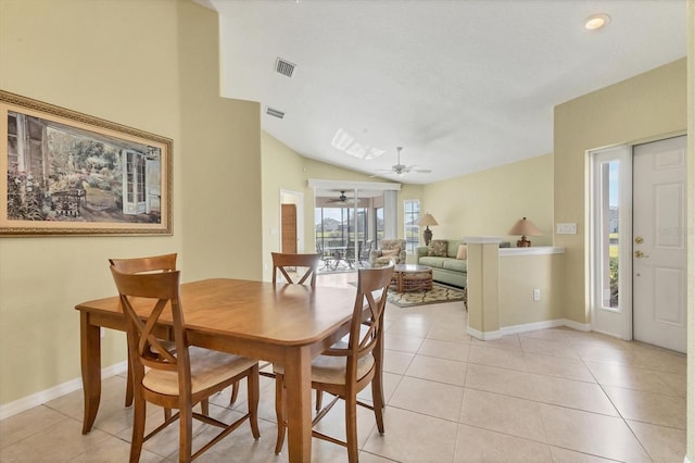 dining area featuring ceiling fan, lofted ceiling, and light tile patterned floors