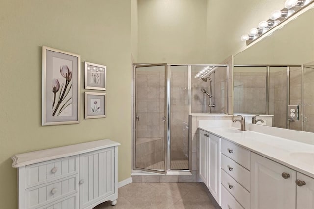 bathroom featuring an enclosed shower, vanity, and tile patterned floors