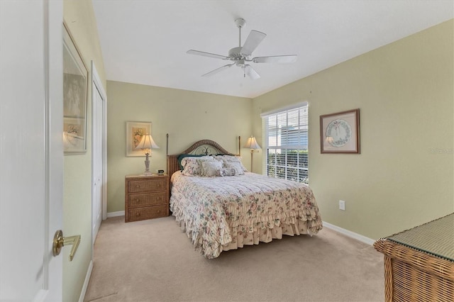 bedroom featuring light carpet and ceiling fan