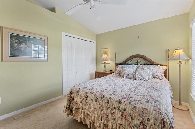 carpeted bedroom featuring ceiling fan, lofted ceiling, and a closet