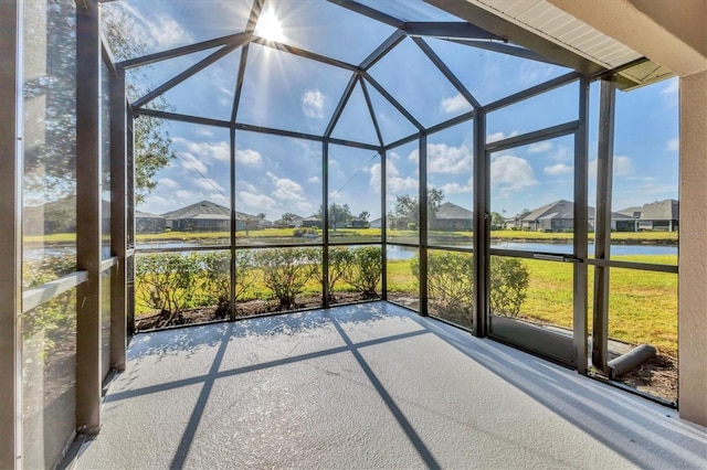 unfurnished sunroom with a water view