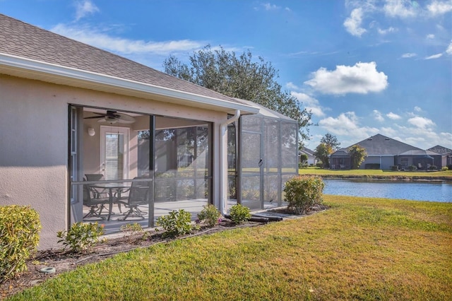 view of yard with a water view, ceiling fan, and a patio