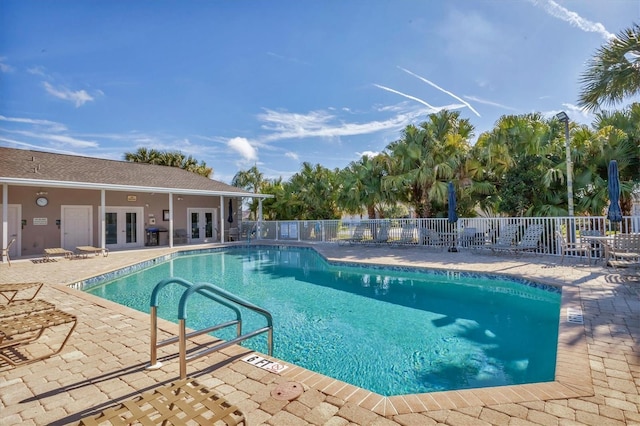 view of swimming pool with a patio and french doors