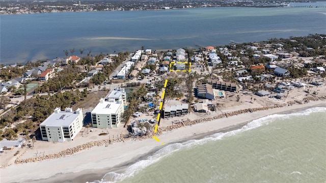 drone / aerial view featuring a view of the beach and a water view