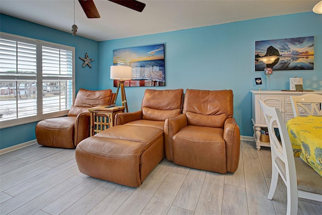 living room featuring ceiling fan and light wood-type flooring