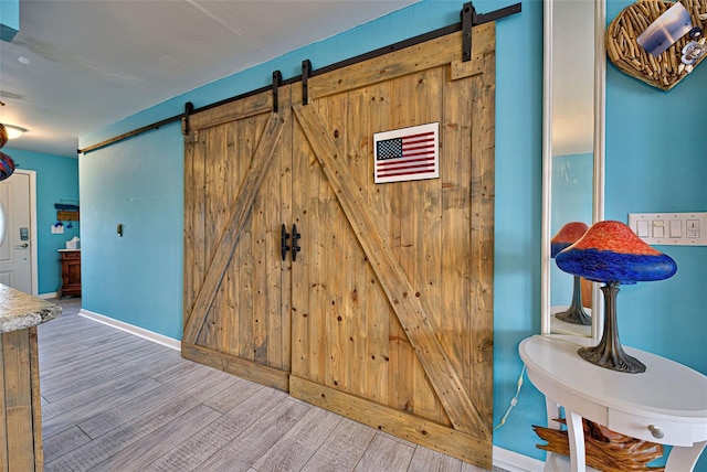 interior space with hardwood / wood-style floors and a barn door