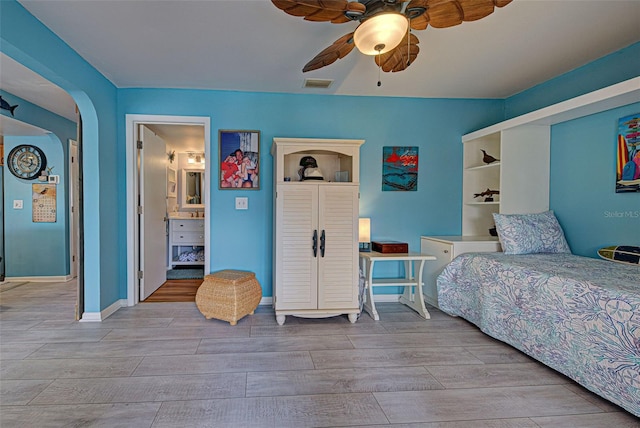 bedroom featuring ceiling fan, ensuite bathroom, and light hardwood / wood-style floors