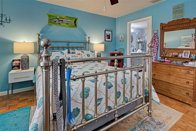 bedroom with ceiling fan and light parquet floors