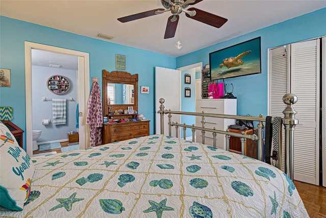 bedroom featuring ceiling fan, parquet flooring, and ensuite bathroom