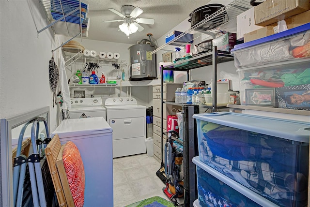 washroom featuring electric water heater, washer and dryer, a textured ceiling, and ceiling fan