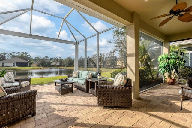 view of patio featuring a water view, ceiling fan, outdoor lounge area, and glass enclosure