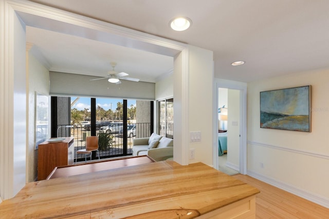 unfurnished dining area featuring ceiling fan, crown molding, and hardwood / wood-style flooring