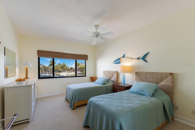 bedroom with ceiling fan and light carpet