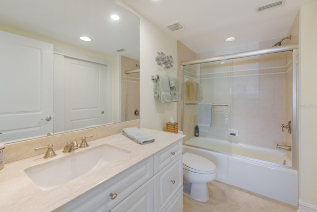 full bathroom featuring toilet, combined bath / shower with glass door, tile patterned floors, and vanity