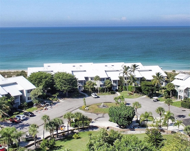 birds eye view of property with a beach view and a water view