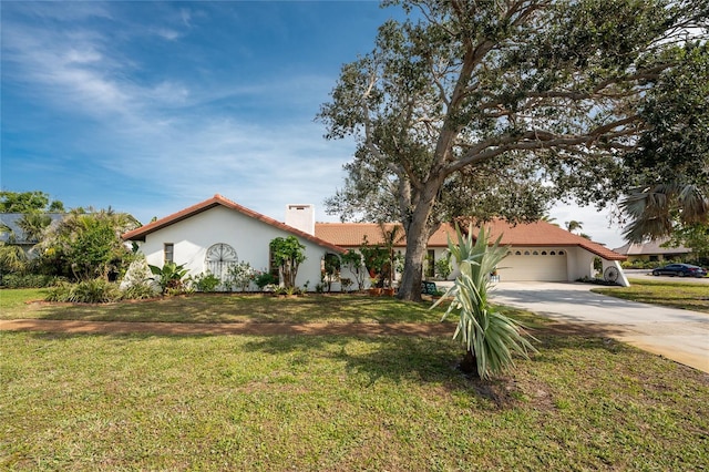 mediterranean / spanish home with a garage and a front yard