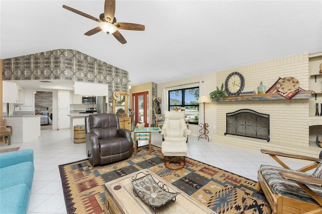 tiled living room with ceiling fan, sink, and a brick fireplace