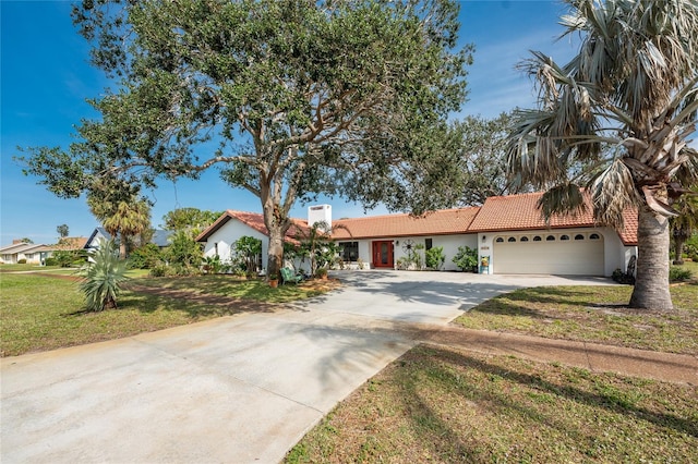 view of front of house with a garage and a front lawn