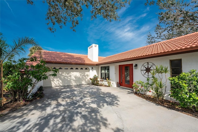 mediterranean / spanish-style house with a garage