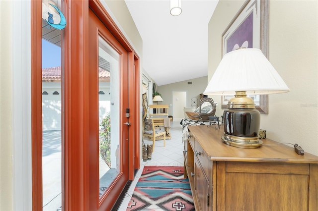 doorway to outside featuring plenty of natural light and vaulted ceiling