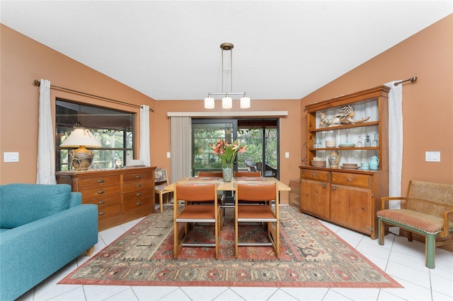 tiled dining area with lofted ceiling