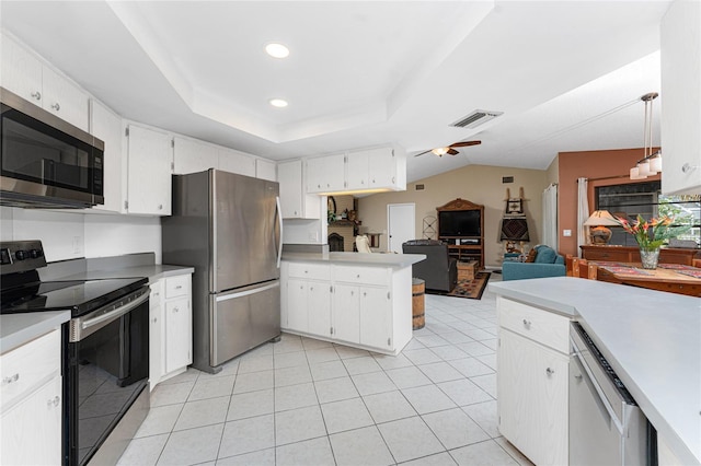 kitchen featuring stainless steel appliances, hanging light fixtures, and white cabinets