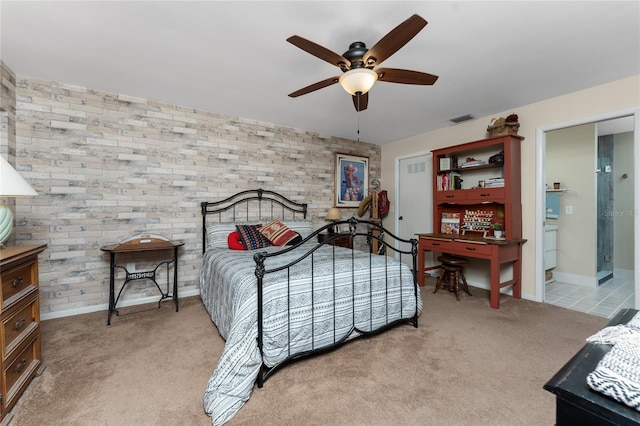 bedroom featuring light carpet, ensuite bath, and ceiling fan