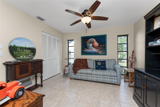 living room with light tile patterned flooring and ceiling fan