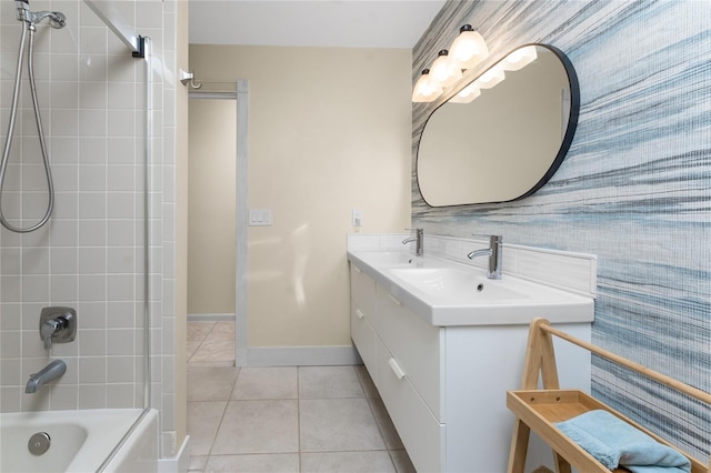 bathroom with tile patterned floors, tiled shower / bath combo, and vanity