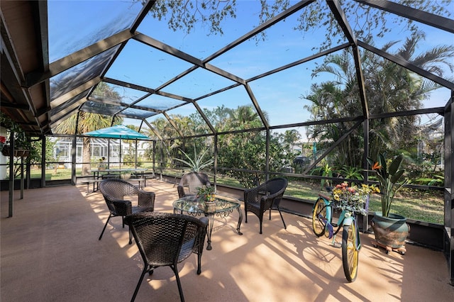 view of patio featuring glass enclosure