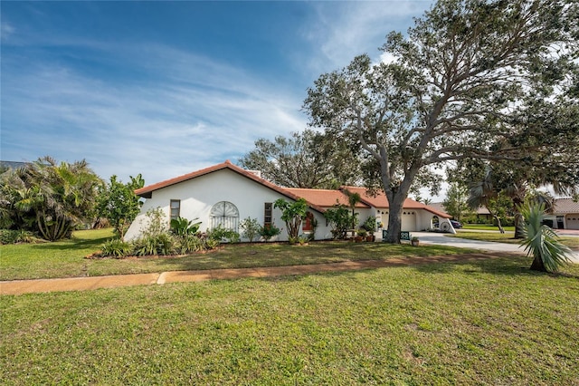 view of front of property with a garage and a front yard