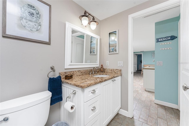 bathroom with vanity and toilet