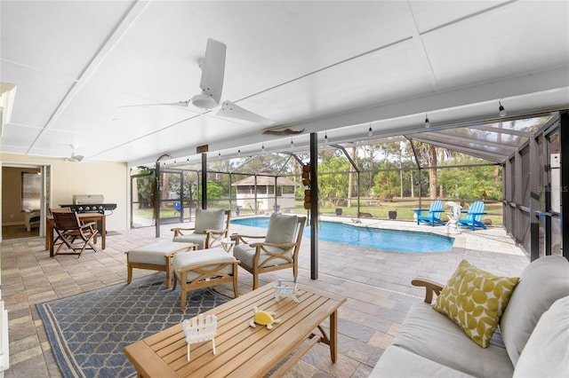 view of pool with a lanai, ceiling fan, and a patio area