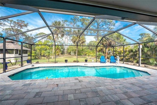 view of swimming pool featuring a lanai and a patio