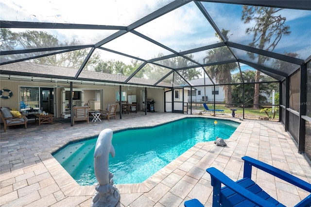 view of swimming pool featuring a patio and a lanai