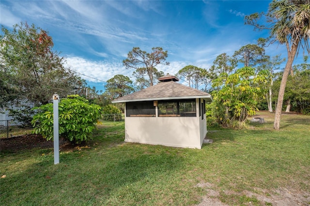 view of outdoor structure featuring a lawn