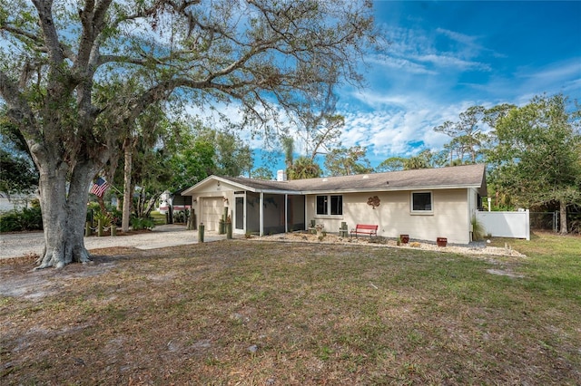 rear view of house with a garage and a yard