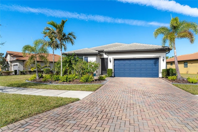 view of front of house with a garage and a front lawn