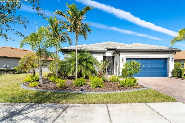 view of front of property with a garage and a front lawn