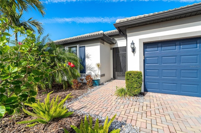 view of exterior entry with a garage