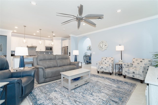 tiled living room featuring crown molding and ceiling fan