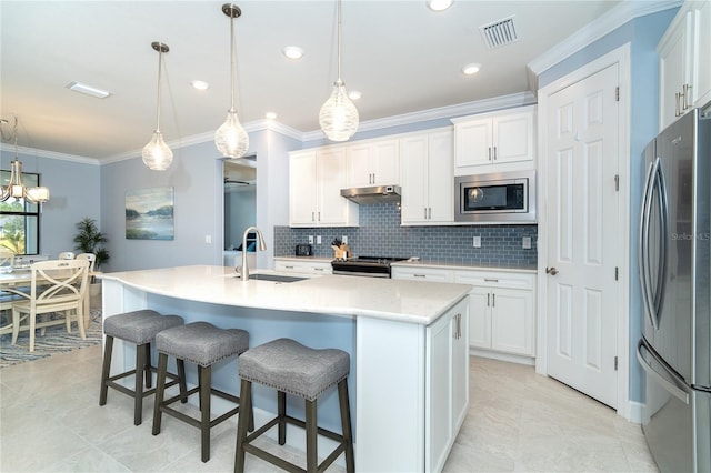 kitchen featuring sink, a kitchen island with sink, white cabinetry, hanging light fixtures, and stainless steel appliances